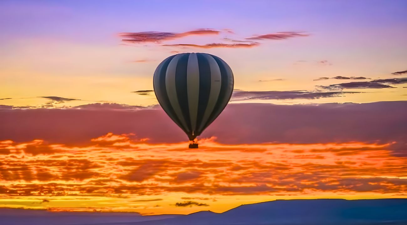 A hot air balloon floating against a breathtaking sunset sky with vibrant orange, pink, and purple hues—perfect for a romantic Valentine's Day experience
