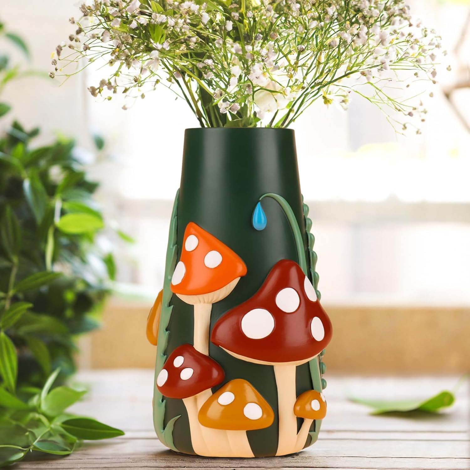 Dark green ceramic vase adorned with cartoon-style red and orange mushrooms and a blue droplet detail.