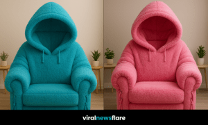 Beige fleece hoodie armchair with hood and drawstrings in a neutral modern room with wooden flooring.