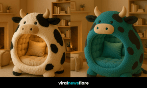 A cosy living room featuring a white and black cow-shaped lounge pod chair near a fireplace and bookshelves.