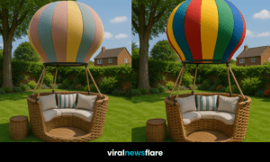 A wicker garden sofa with a pastel balloon-shaped canopy set in a colourful, flower-filled British garden.