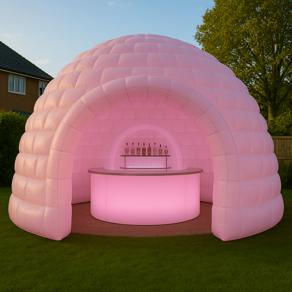Inflatable igloo bar lit with pink LED lights in a garden