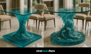 Artistic ocean-inspired table with glass top and resin wave base in a modern room setting