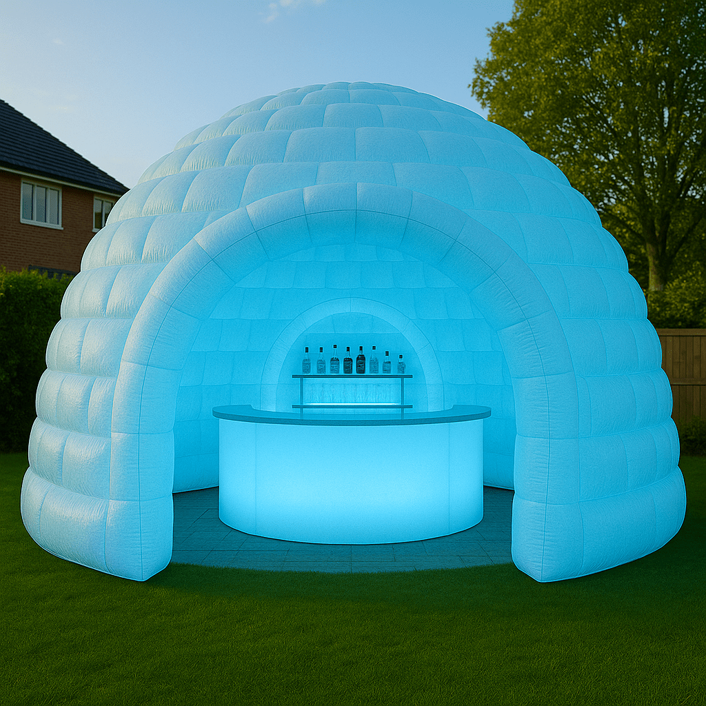 Glowing inflatable igloo bar with blue LED lighting in a garden setting