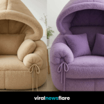 Neutral beige hooded armchair in a minimalist living room with natural daylight.