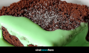 Close-up of classic British school dessert chocolate concrete topped with green mint custard and a sprinkle of sugar.