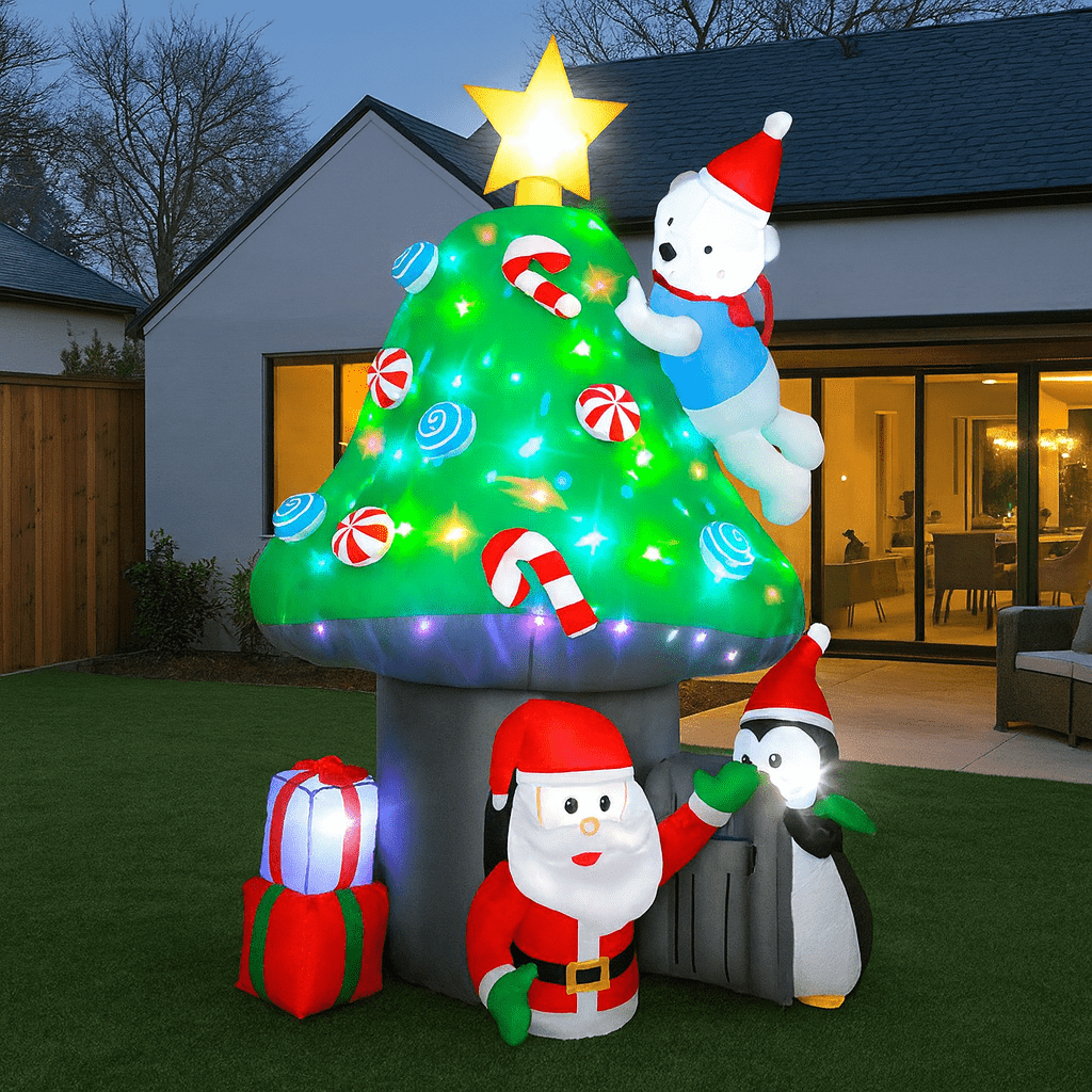 Large inflatable Christmas tree featuring Santa and penguins with LED lights in a garden